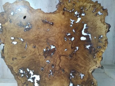 Irregular live-edge burl wood slab with rich grain and natural imperfections, perfect for handcrafted tables and doors.