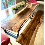 Handcrafted live-edge wooden dining table with natural grain, part of a premium solid-wood furniture collection including doors.