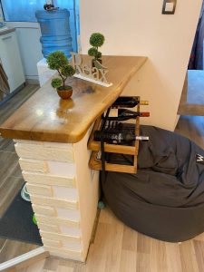 Handcrafted wooden bar counter with a brick base, part of our custom wooden tables and doors collection.