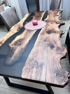 Handcrafted live-edge wooden river table with an epoxy resin inlay, showcased as a sample of custom wooden tables.