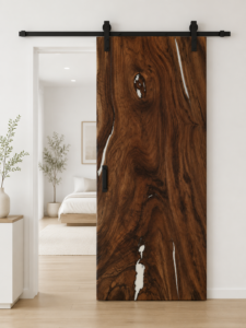 Handcrafted wooden sliding barn door with rich grain installed in a bright modern room.