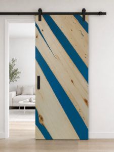 Handcrafted wooden sliding door with blue diagonal stripes and black hardware, showcased in a modern living space for custom doors and wooden furniture.