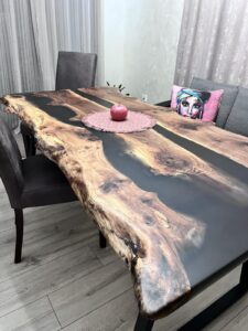 Handcrafted live-edge wooden dining table with resin inlay, showcased in a modern dining room as part of our wooden tables and doors collection.
